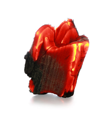 Piece of smoldering coal isolated on whiteの写真素材