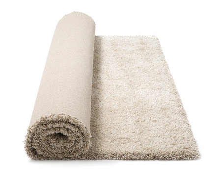 Rolled fuzzy carpet on white background. Interior elementの写真素材