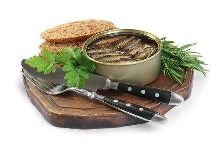Board with canned sprats, herbs, bread and cutlery isolated on whiteの写真素材