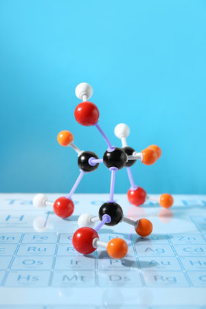 Molecular model on periodic table against light blue backgroundの写真素材