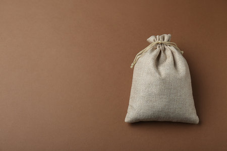Burlap bag on brown background, top view. Space for textの写真素材