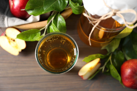 Flat lay composition with delicious apple cider on wooden table