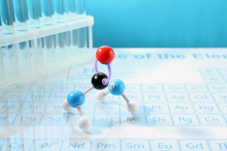 Molecular model and test tubes on periodic table against light blue background. Space for textの写真素材