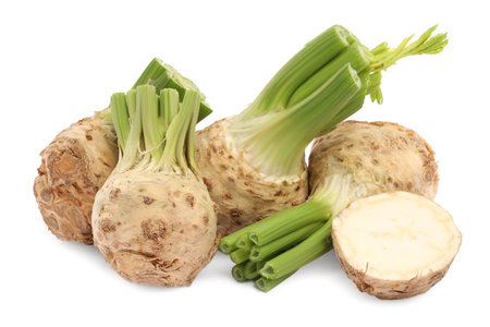 Whole and cut celery roots isolated on white