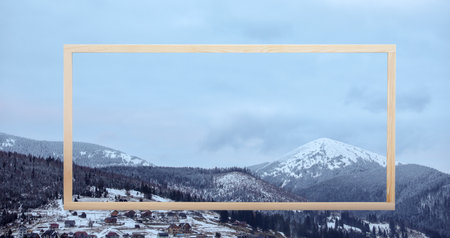 Wooden frame and beautiful mountains covered with snow in winter, banner design