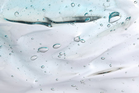 Transparent cleansing gel on light gray background, closeup. Cosmetic product