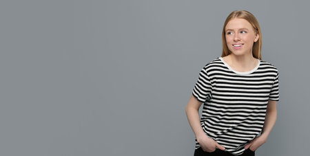 Portrait of beautiful young woman on grey background. Banner design with space for textの写真素材