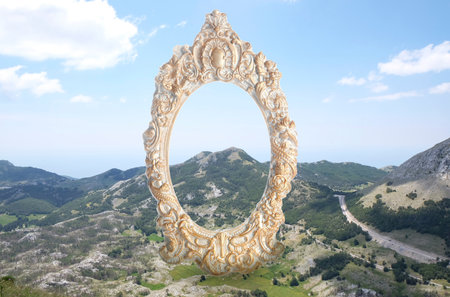 Vintage frame and beautiful mountains under blue sky with cloudsの写真素材