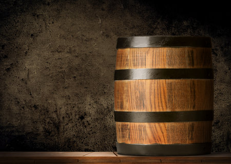 One wooden barrel against dark textured background, space for textの写真素材
