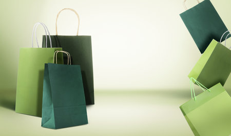 Hot sale. Colorful shopping bags on light green gradient background, space for textの写真素材