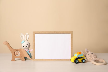 Empty square frame and different toys on white tableの写真素材
