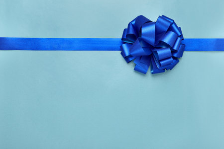 Ribbon with bow on light blue background, top view. Space for textの写真素材
