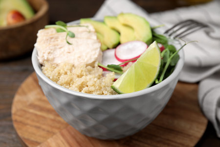 Delicious quinoa salad with chicken, avocado and radish served on table, closeupの写真素材