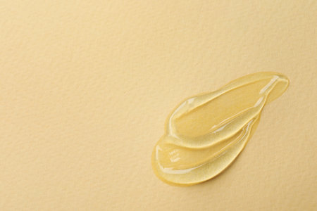 Swatches of cosmetic gel on beige background, closeup. Space for text