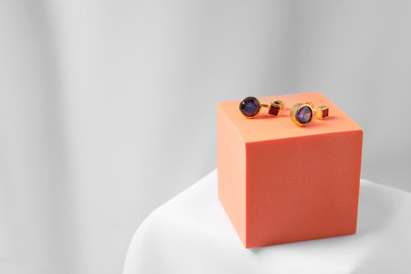 Stylish presentation of earrings on white background, space for textの写真素材