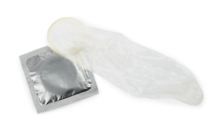 Unrolled condom and package on white background, top view. safe sexの写真素材