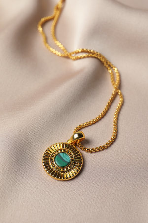 Elegant necklace on beige cloth. Stylish bijouterieの写真素材
