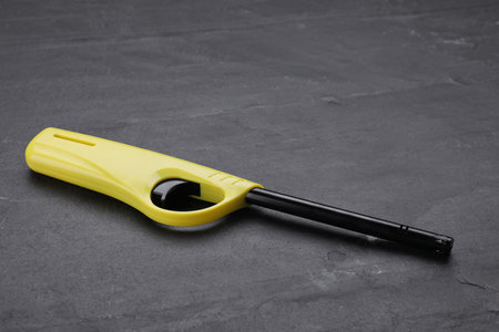 One gas lighter on black textured backgroundの写真素材