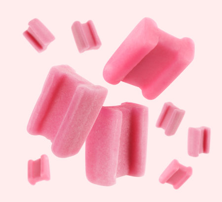 Many bubble gum pillows falling on light background