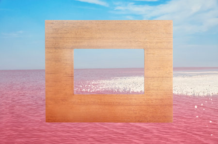 Wooden frame and beautiful pink lake under blue sky with clouds