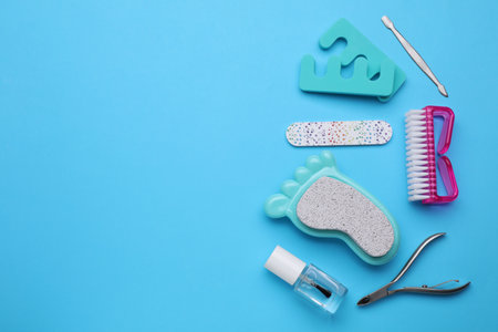Set of pedicure tools on light blue background, flat lay. Space for textの写真素材