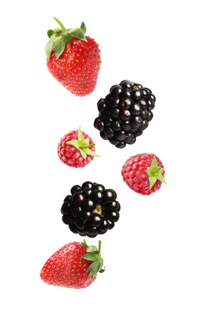 Blackberries, strawberries and raspberries falling on white background