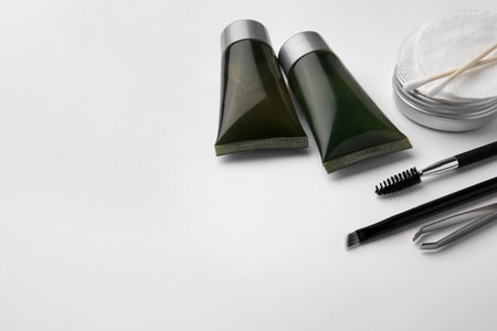 Eyebrow henna and professional tools on white background, space for textの写真素材