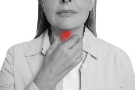 Endocrine system. Woman doing thyroid self examination on white background, closeup. Color accent effectの写真素材