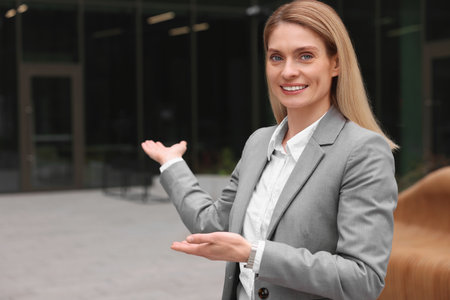 Happy real estate agent outdoors. Space for textの写真素材