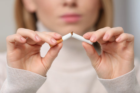 Stop smoking concept. Woman breaking cigarette, closeupの写真素材