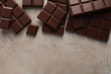 Delicious dark chocolate on gray table, flat lay. Space for textの写真素材