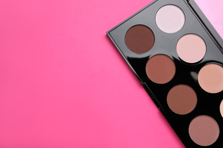 Colorful contouring palette on pink background, top view with space for text. Professional cosmetic productの写真素材