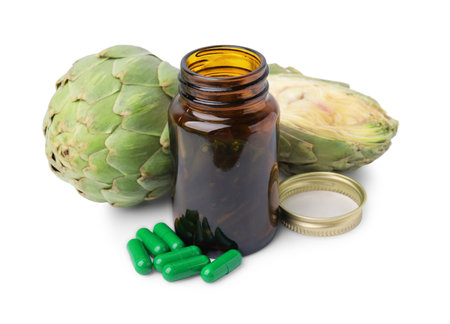 Fresh artichokes and bottle of pills isolated on whiteの写真素材