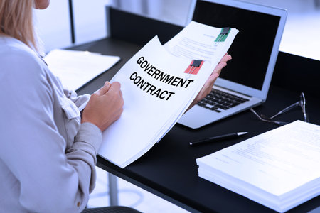 Government contract. Woman reading document at table, closeupの写真素材