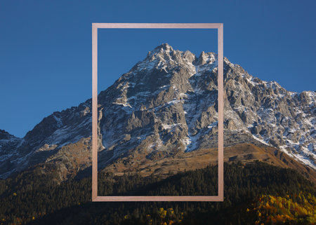 Wooden frame and beautiful mountains under blue sky