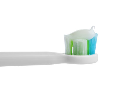 Electric toothbrush with paste on white background, closeup