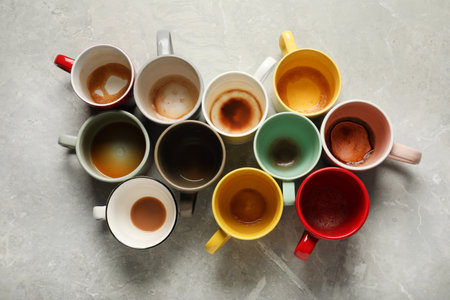 Many dirty cups after different coffee drinks on light gray marble table, flat layの写真素材