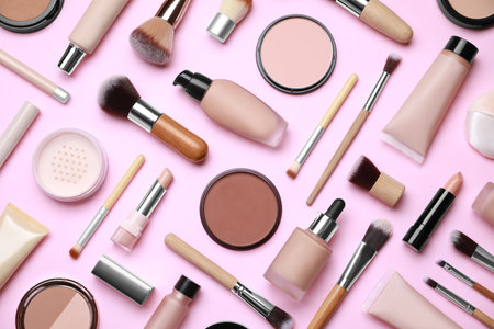 Face powders and other decorative cosmetic products on pink background, flat layの写真素材