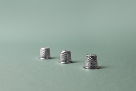 Three thimbles on pale olive background. Thimblerig gameの写真素材