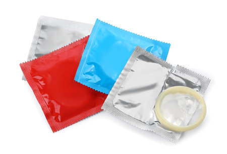 Packages and unpacked condom isolated on white, top view. Safe sexの写真素材