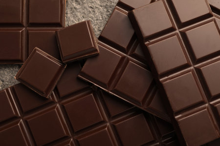 Delicious dark chocolate on gray table, closeup