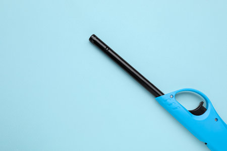 One gas lighter on light blue background, top view. Space for textの写真素材