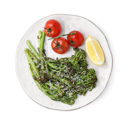 Tasty cooked broccolini with cheese, tomatoes and lemon isolated on white, top viewの写真素材