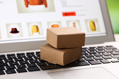 Mini boxes on laptop, closeup. Online storeの写真素材