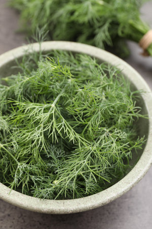 Bowl of fresh dill on gray table, closeupの写真素材