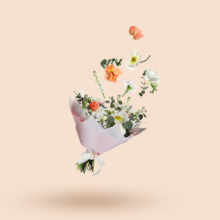 Different flowers falling into beautiful bouquet on beige backgroundの写真素材