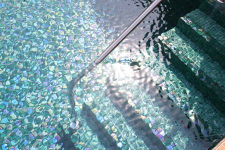 Outdoor swimming pool with steps and rail at resort