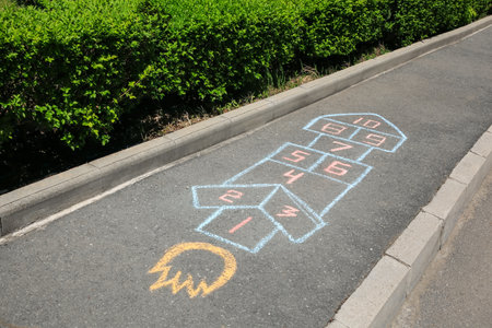 Hopscotch drawn with colorful chalk on asphalt outdoorsの写真素材