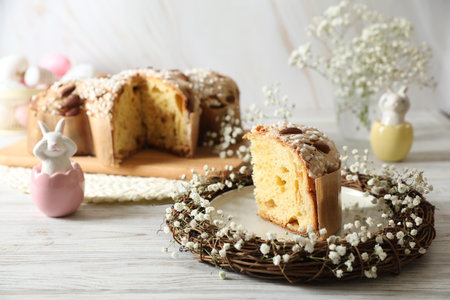 Delicious Italian Easter dove cake (traditional Colomba di Pasqua) in nest and festive decor on...