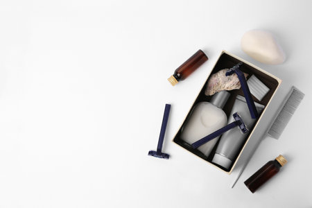 Different men's shaving accessories and box on white background, flat lay. Space for textの写真素材